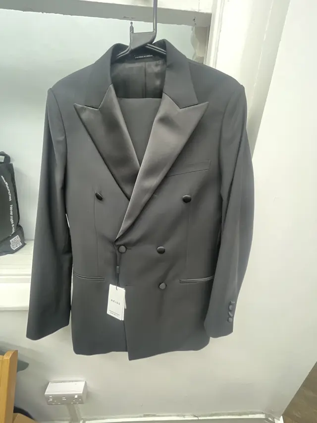 A grey double-breasted jacket with peak lapels