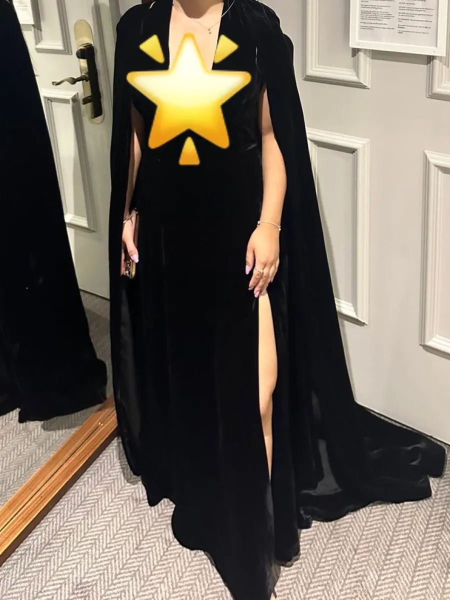 A full-length black velvet cape gown made in the workshop